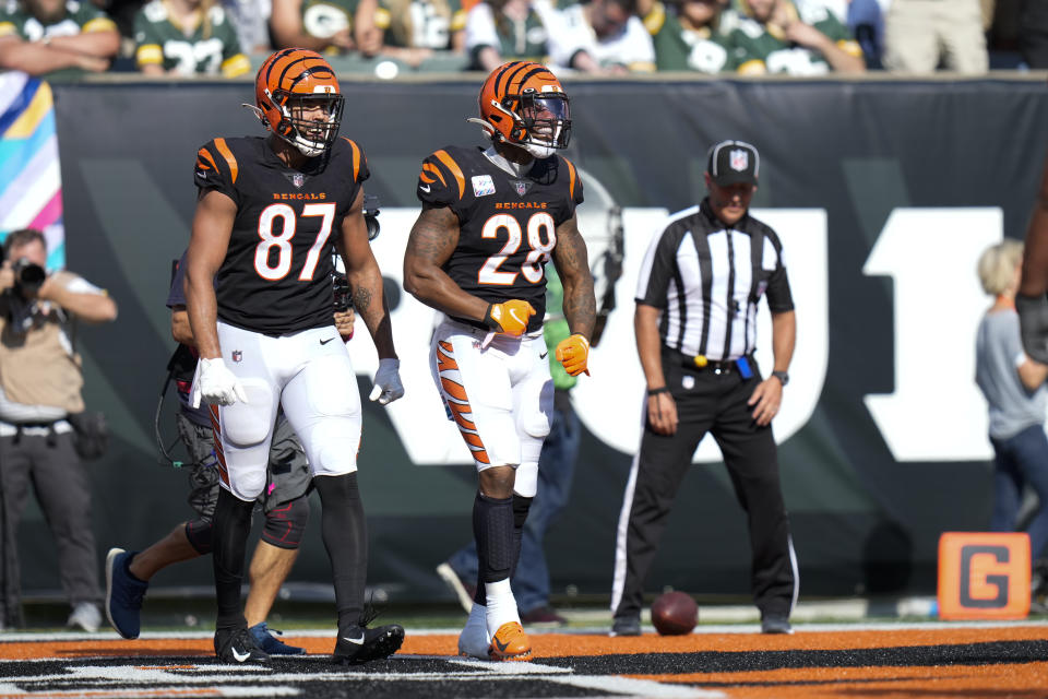 Cincinnati Bengals running back Joe Mixon (28) celebrates with tight end C.J. Uzomah (87) after a touchdown in the second half of an NFL football game against the Green Bay Packers in Cincinnati, Sunday, Oct. 10, 2021. (AP Photo/AJ Mast)
