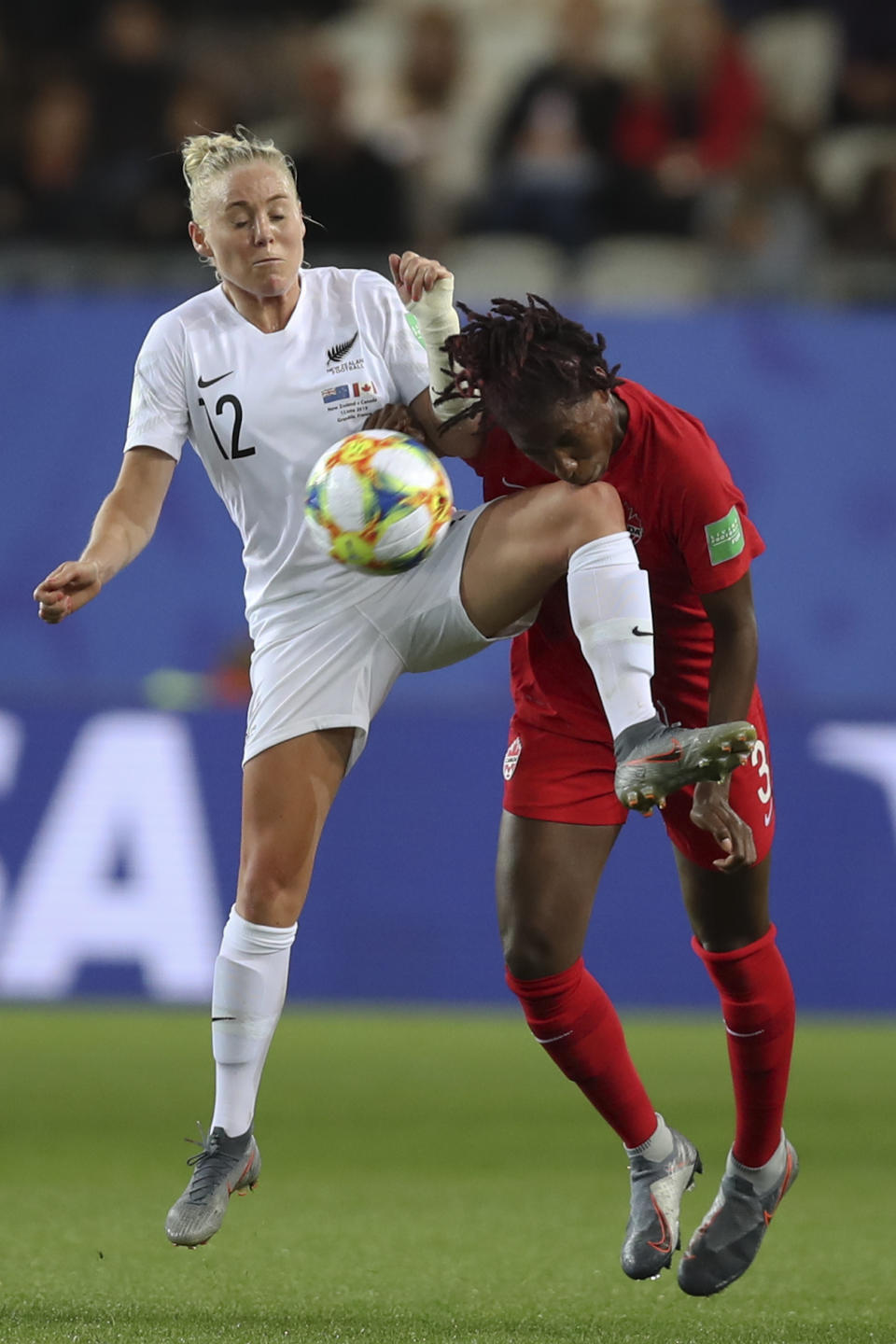 Canada's Kadeisha Buchanan compete for the ball with New Zealand's Betsy Hassett during the Women's World Cup Group E soccer match between Canada and New Zealand in Grenoble, France, Saturday, June 15, 2019. (AP Photo/Francisco Seco)