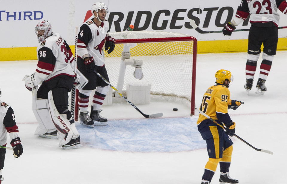 Nashville Predators' Matt Duchene (95) skates to teammates after they scored on Arizona Coyotes goalie Darcy Kuemper (35) as Niklas Hjalmarsson (4) digs the puck out of the net during first period NHL qualifying round game action in Edmonton, on Sunday, Aug. 2, 2020. (Jason Franson/The Canadian Press via AP)