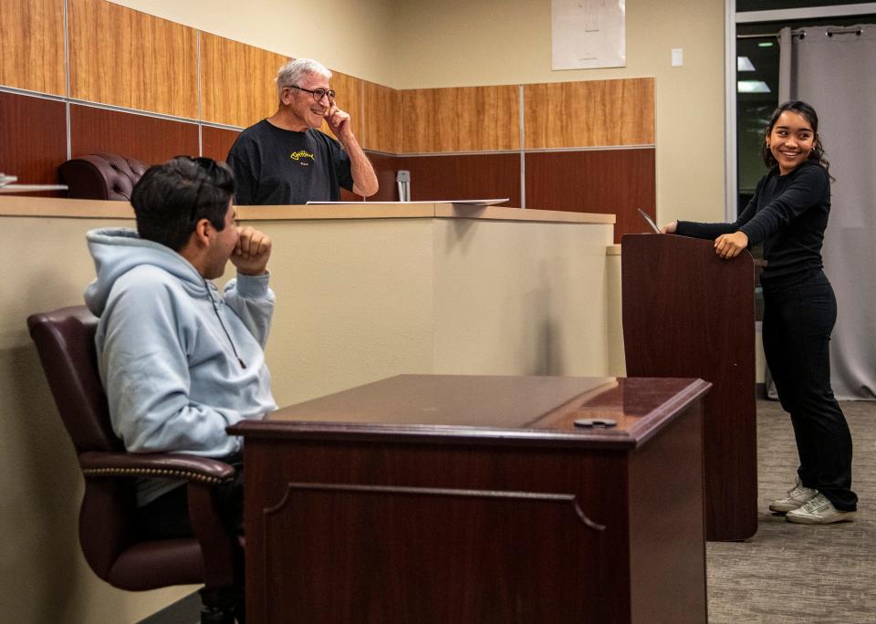 Coach Joel Mark, standing in as judge, smiles as lead defense attorney Victoria Sung cross-examines victim Lucas Maduena during mock trial practice last week at Indio High School.