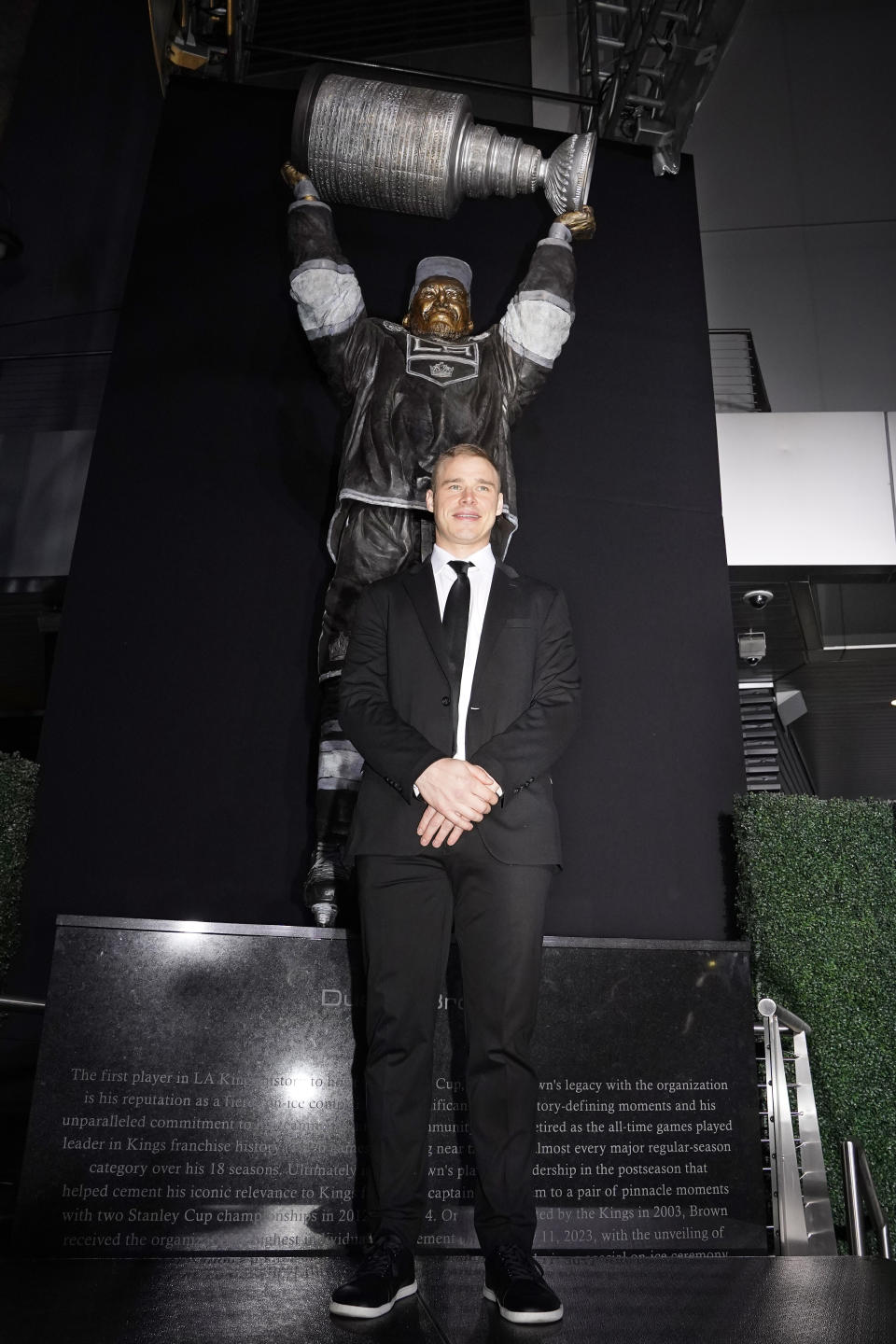 Former Los Angeles Kings right winger Dustin Brown poses during a ceremony to unveil his statue prior to an NHL hockey game between the Los Angeles Kings and the Pittsburgh Penguins Saturday, Feb. 11, 2023, in Los Angeles. (AP Photo/Mark J. Terrill)