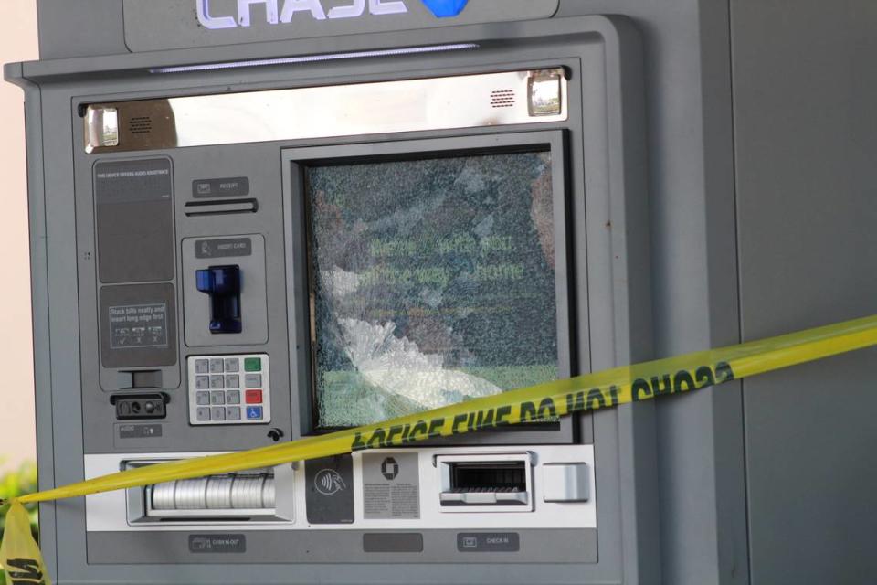 An ATM was shattered by a bullet at a West Kendall Chase Bank that was the scene of a murder-suicide that left two adults dead and a child.