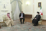 In this photo released by the official website of the office of the Iranian Presidency, President Ebrahim Raisi, right, meets with United Arab Emirates' top national security adviser Sheikh Tahnoon bin Zayed Al Nahyan, left, in Tehran, Iran, Monday, Dec. 6, 2021. Sheikh Tahnoon's visit comes as the Emirates and Saudi Arabia both negotiate with Iran amid efforts in Vienna to save Tehran’s tattered nuclear deal with world powers. An unidentified interpreter sits at center. (Iranian Presidency Office via AP)