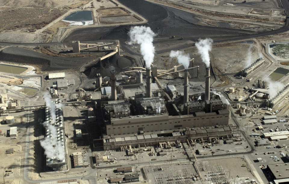 FILE - This Nov. 9, 2009, file photo shows the coal-fired San Juan Generating Station near Farmington, N.M. Proponents of New Mexico's energy industry say emails exchanged among environmentalists and a key member of Gov. Michelle Lujan Grisham's cabinet represent a conflict of interest as the state was creating landmark legislation that set ambitious new renewable energy goals.(AP Photo/Susan Montoya Bryan, File)