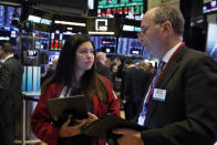 Traders Ashley Lara and Gordon Charlop work on the floor of the New York Stock Exchange, Tuesday, Nov. 12, 2019. Stocks are opening slightly higher on Wall Street, led by gains in technology and health care companies. (AP Photo/Richard Drew)