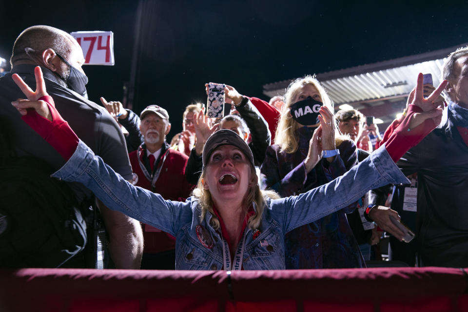 Supporters of President Donald Trump cheer as he arrives to speak at a campaign rally at Central Wisconsin Airport, Thursday, Sept. 17, 2020, in Mosinee, Wis. (AP Photo/Evan Vucci)