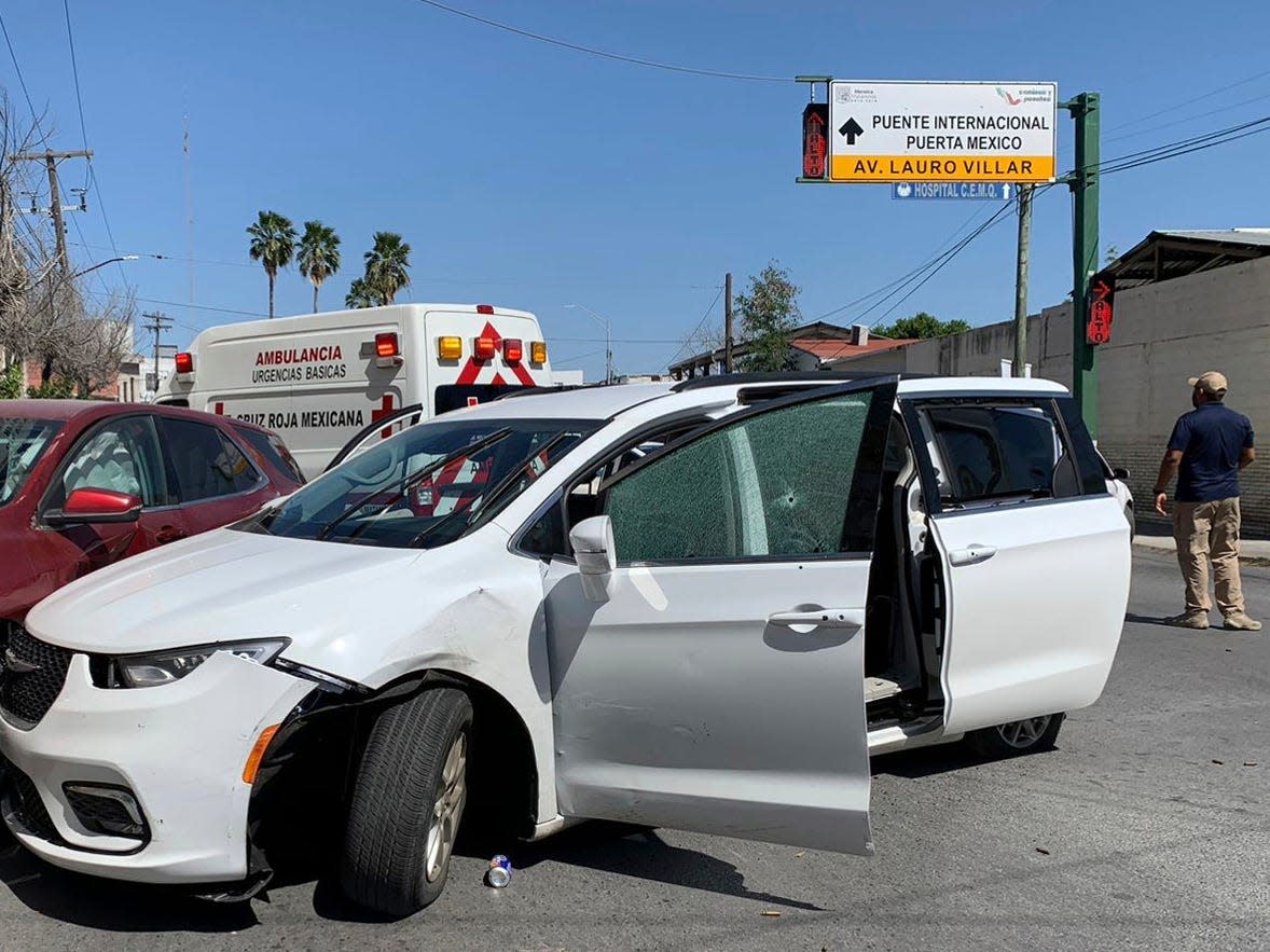 A member of the Mexican security forces stands next to a white minivan with North Carolina plates and several bullet holes, at the crime scene where gunmen kidnapped four U.S. citizens who crossed into Mexico from Texas, Friday, March 3, 2023.