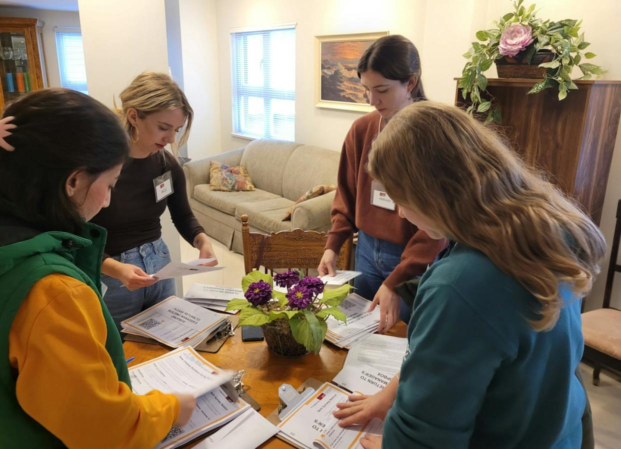 Simon Fraser University students compile survey packages for a community housing resident survey in North Vancouver in November 2023. (Meg Holden), Author provided