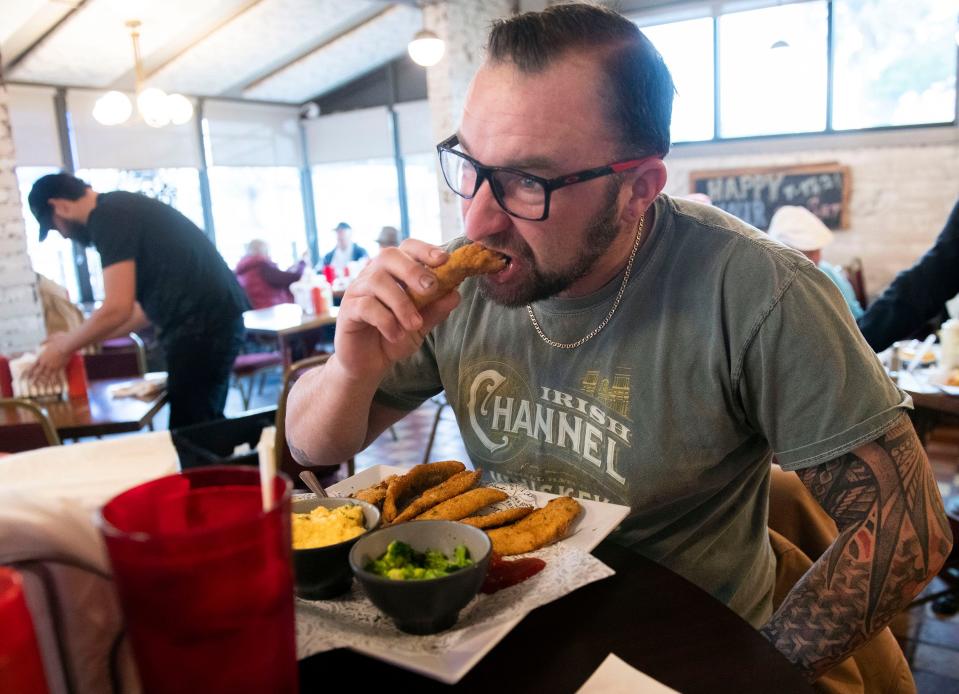 Devin Heindel visits Captain Joey Patti's Seafood on Garden Street in downtown Pensacola for the fried mullet on Wednesday, Jan. 3, 2023.