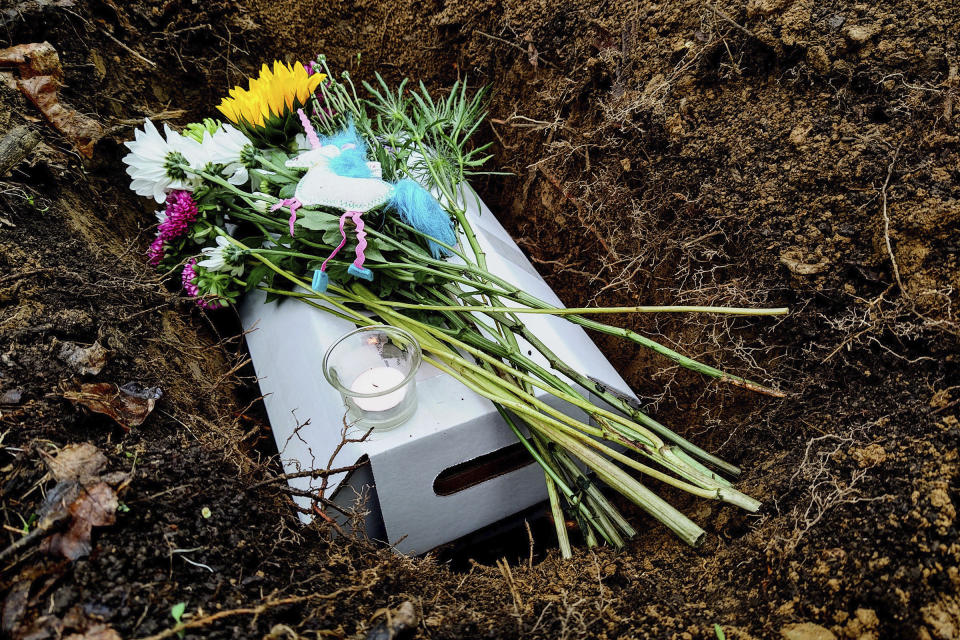 This image provided by Sarah Bown, shows the burial following an animal funeral for "Buddy" the cat in May, 2021. (Sarah Bowen via AP)