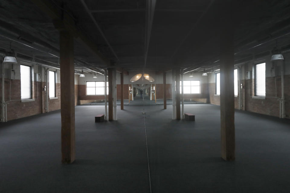 In this April 1, 2020, photo, the large Hot Room is seen inside Naveed Abidi's Bikram Yoga West, which is empty of members after being closed by the city last week in Chicago. The studio believed it qualified as an essential health and wellness service. "It was not like an act of rebellion or anything," said Abidi, who faces a fine of up to $10,000. "If we were naughty with the government's order, then we're very, very sorry. We're not here to cause problems, we're here to practice our poses." (AP Photo/Charles Rex Arbogast)