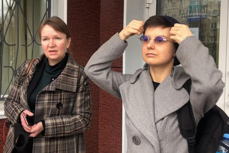CORRECTS ID OF PERSON ON LEFT In this image taken from The Associated Press video, feminist activist and artist Yulia Tsvetkova, right, and her lawyer Irina Ruchko speak to the media after visiting a court session in Komsomolsk-on-Amur, Russia, Monday, April 12, 2021. A Russian court on Monday opened the trial of Yulia Tsvetkova charged with disseminating pornography after she shared artwork depicting female genitalia online -- a case in line with the Kremlin’s conservative stance promoting “traditional family values.” (AP Photo/Alexander Permyakov)