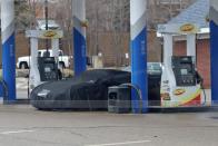 <p>With the car sitting unresponsive at the gas pump, the engineering team decided to whip out the car cover at this point to thwart any onlookers from seeing more of the car's styling.</p>