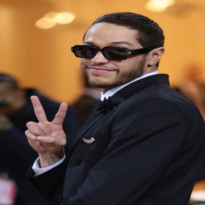 Pete wearing sunglasses hand giving the peace sign while at the MET Gala