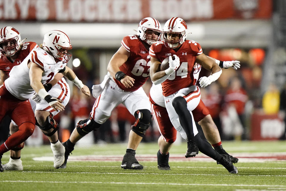 Wisconsin's Jackson Acker runs during the second half of an NCAA college football game against Nebraska Saturday, Nov. 18, 2023 in Madison, Wis. (AP Photo/Aaron Gash)