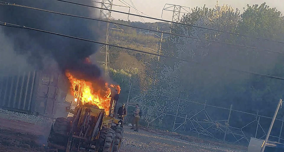 FILE - This image provided by the Atlanta Police Department shows construction equipment set on fire Saturday, March 4, 2023, by a group protesting the planned public safety training center in DeKalb County, Ga. State and local police arrested three people on Wednesday, May 31, 2023 who run a fund that bails out protesters, accusing them of money laundering and charity fraud. (Atlanta Police Department via AP, File)