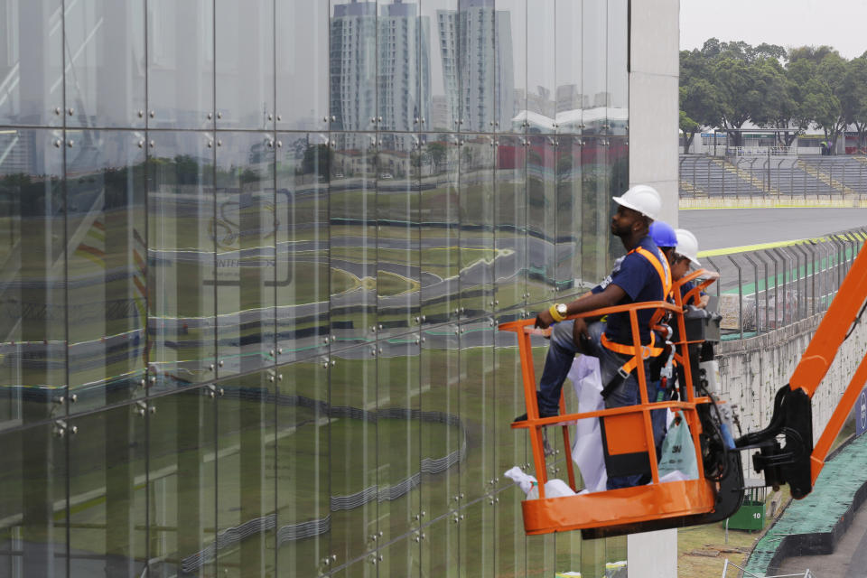 In this Nov. 7, 2019 photo, technicians prepare for the 2019 Brazilian Grand Prix at Interlagos racetrack in Sao Paulo, Brazil. Interlagos can host 60,000 fans per day. (AP Photo/Nelson Antoine)