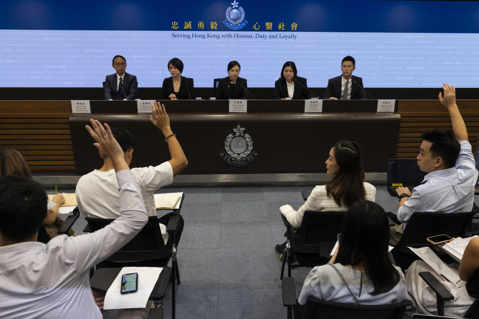 Journalists ask questions during a police presser with from left, Mr Cheng Tak-ka, Director of Enforcement Securities and Futures Commission, Wong Lok-yan Director of licensing and Head of Fintech unit, Ms Kung Hing-fun, Senior Superintendent of Commercial Crime Bureau and Ms Lee Mo-yin, superintendent of Commercial Crime Bureau, after police arrested six people following allegations of fraud at an unlicensed cryptocurrency exchange in Hong Kong, Tuesday, Sept. 19, 2023. (AP Photo/Louise Delmotte)