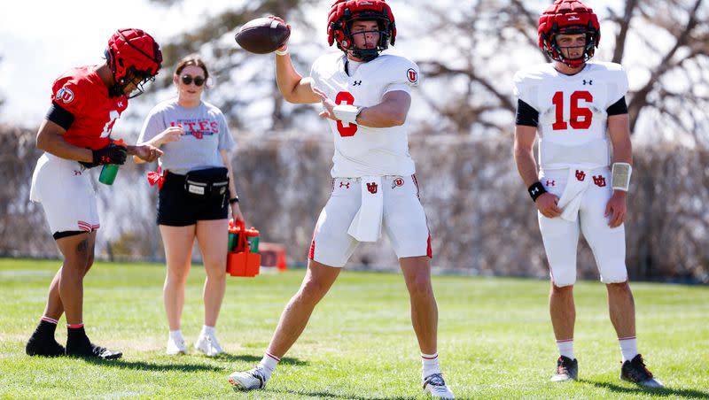 Backup quarterback Brandon Rose throws a pass during Utes spring drills in Salt Lake City, while fellow backup Bryson Barnes looks on.