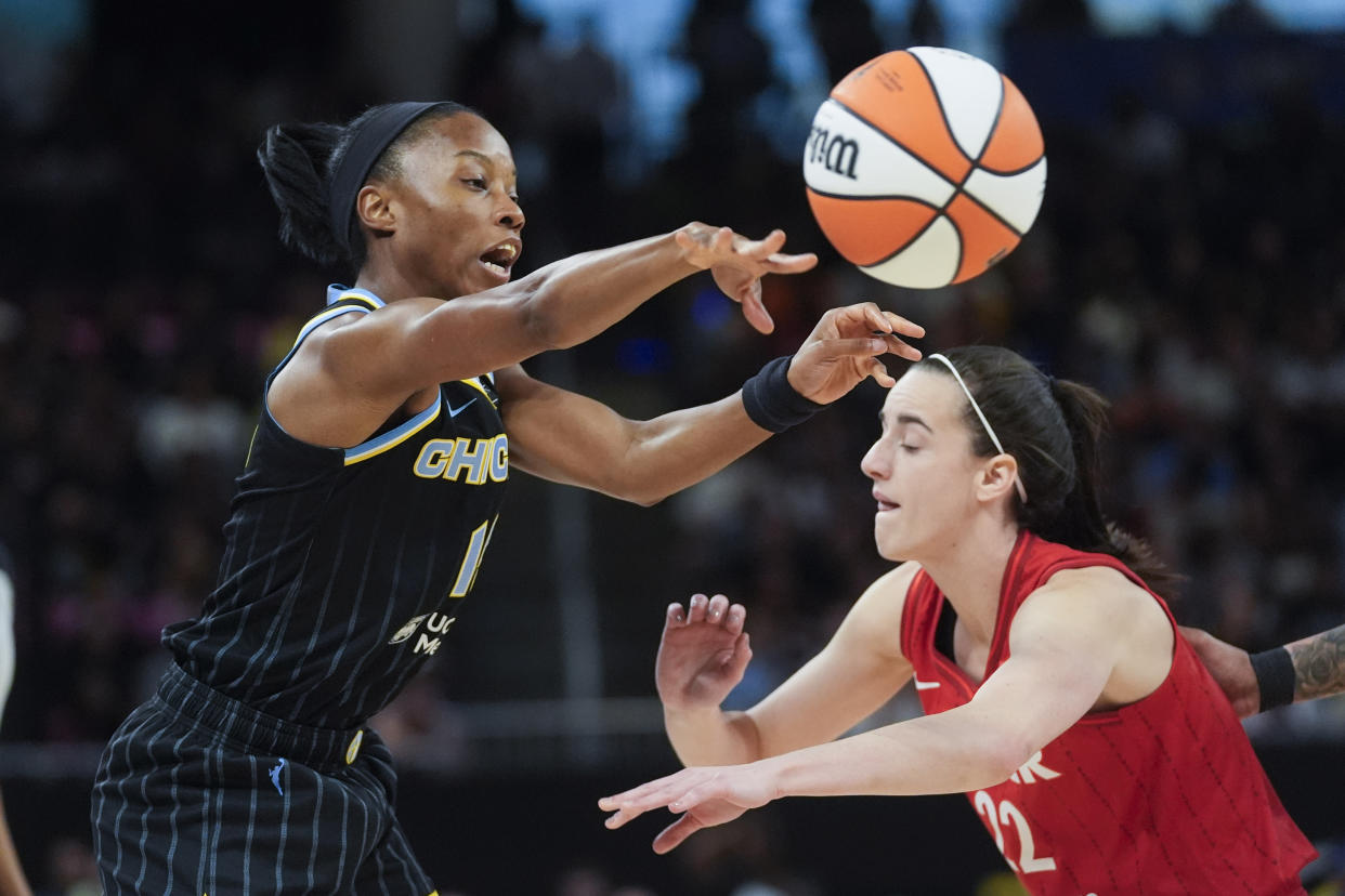 Chicago Sky guard Lindsay Allen, left, passes the ball by Indiana Fever guard Caitlin Clark during the first half of a WNBA basketball game Friday, Aug. 30, 2024, in Chicago. (AP Photo/Erin Hooley)