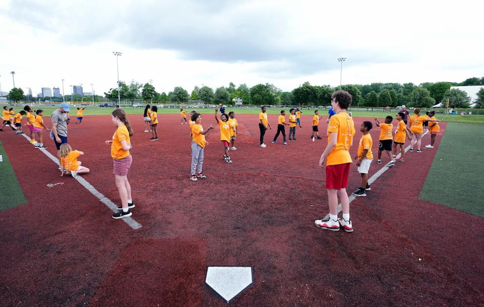 Children learn to catch a ball with one hand during the Greater Columbus Sports Commission's recent Community Youth Camp. Another session will begin Tuesday.