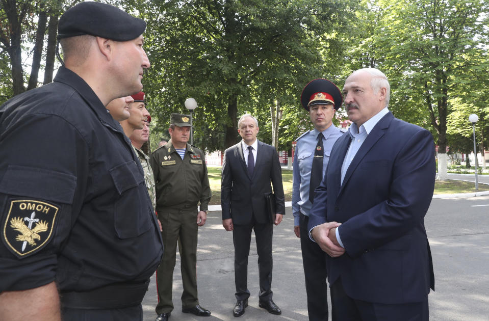 Belarus President Alexander Lukashenko, right, speaks with officers as he visits the Belarusian Interior Ministry special forces base in Minsk, Belarus, Tuesday, July 28, 2020. The presidential election in Belarus is scheduled for Aug. 9, 2020. (Nikolai Petrov/BelTA Pool Photo via AP)