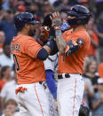 Houston Astros' Carlos Correa, right, celebrates his two-run home run with Yuli Gurriel during the second inning of baseball game against the Toronto Blue Jays, Friday, May 7, 2021, in Houston. (AP Photo/Eric Christian Smith)