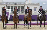 Britain's equestrian team jumping members sit on their horses with their gold medals in Greenwich Park at the London 2012 Olympic Games August 6, 2012. REUTERS/Mike Hutchings (BRITAIN - Tags: SPORT EQUESTRIANISM OLYMPICS) 