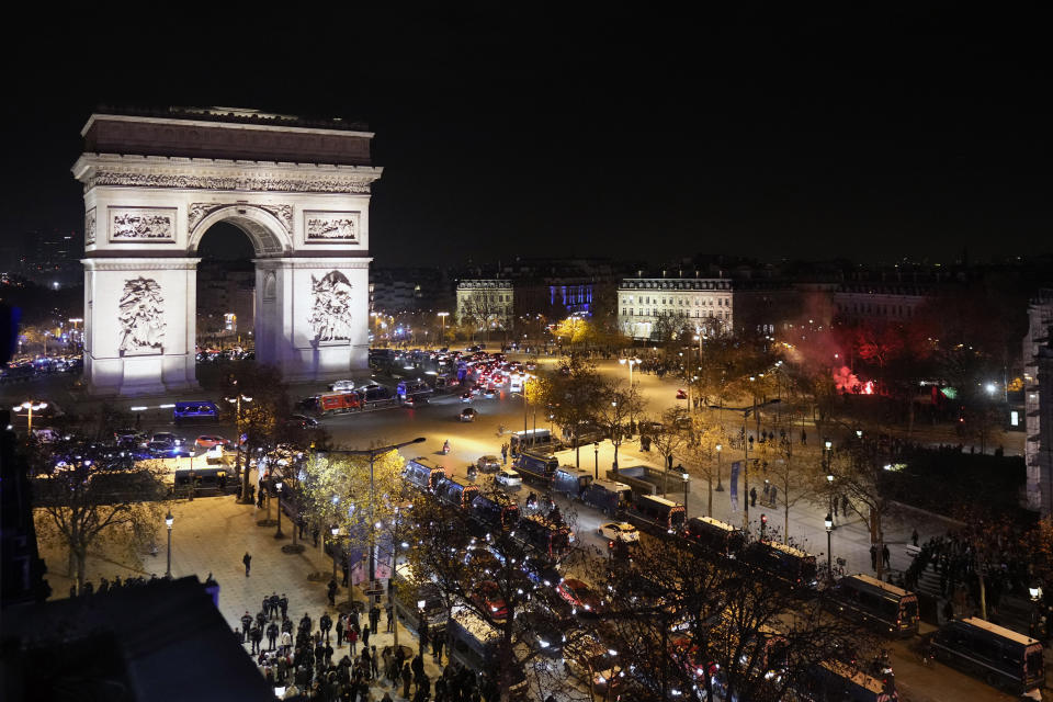 Supporters of France react next to the Arc de Triomphe and the Champs Elysees avenue at the end of the World Cup semifinal soccer match between France and Morocco, in Paris, Wednesday, Dec. 14, 2022. (AP Photo/Thibault Camus)
