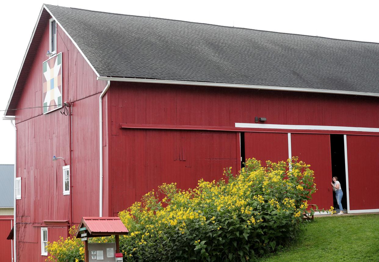 Clara Lamb, venue and marketing coordinator for Crown Point Ecology Center in Bath, closes up the barn doors.