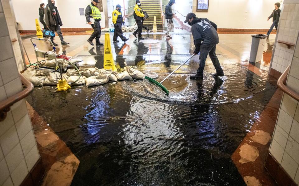 Gerardo Medina cleans up water inside Union Station