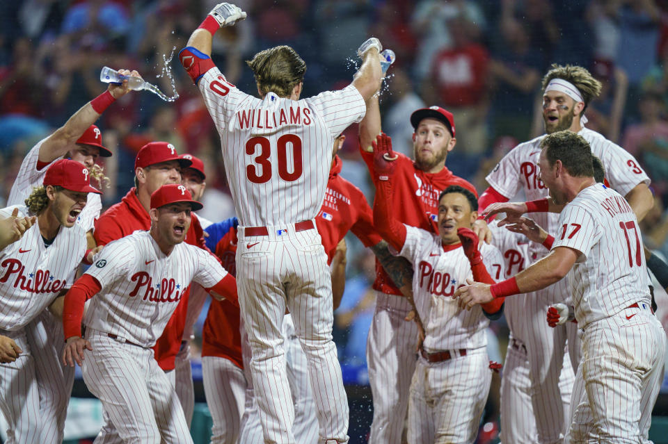 Philadelphia Phillies' Luke Williams is welcomed by teammates after his two-run home run during the ninth inning of a baseball game against the Atlanta Braves, Wednesday, June 9, 2021, in Philadelphia. The Phillies won 2-1. (AP Photo/Chris Szagola)