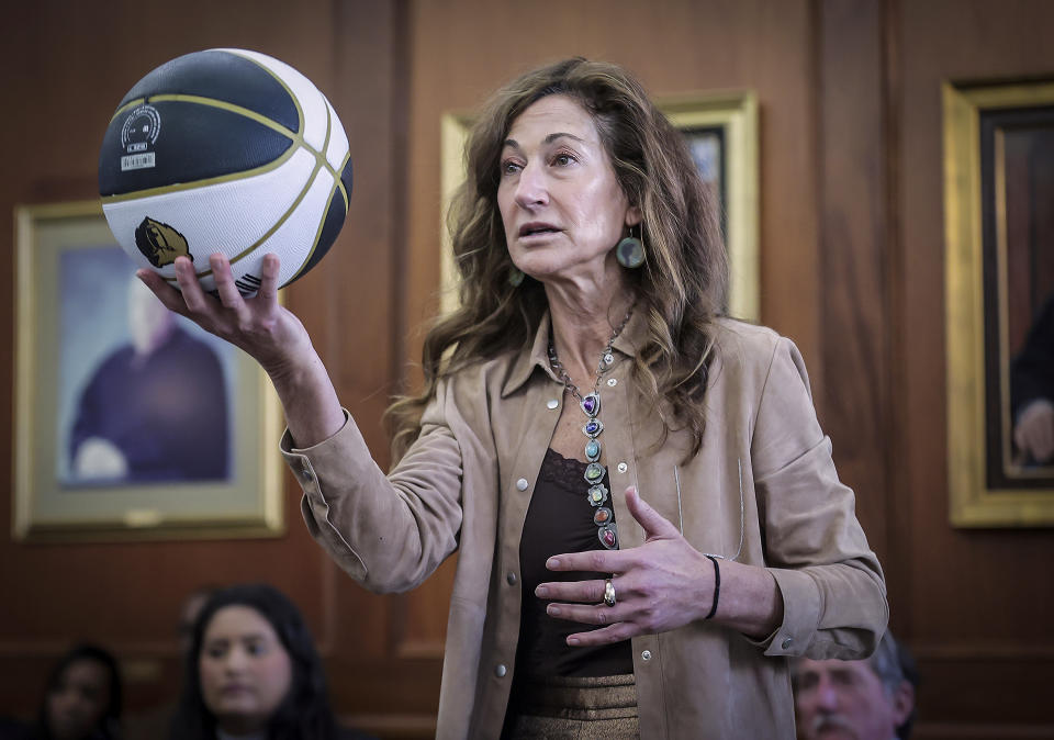 Attorney Rebecca Adelman holds up a basketball while examining a witness at a hearing in Judge Carol Chumney's courtroom on Tuesday, Dec. 12, 2023, in Memphis, Tenn. The hearing is to determine whether Ja Morant used self defense during a fight last summer at his home. (Patrick Lantrip/Daily Memphian via AP)