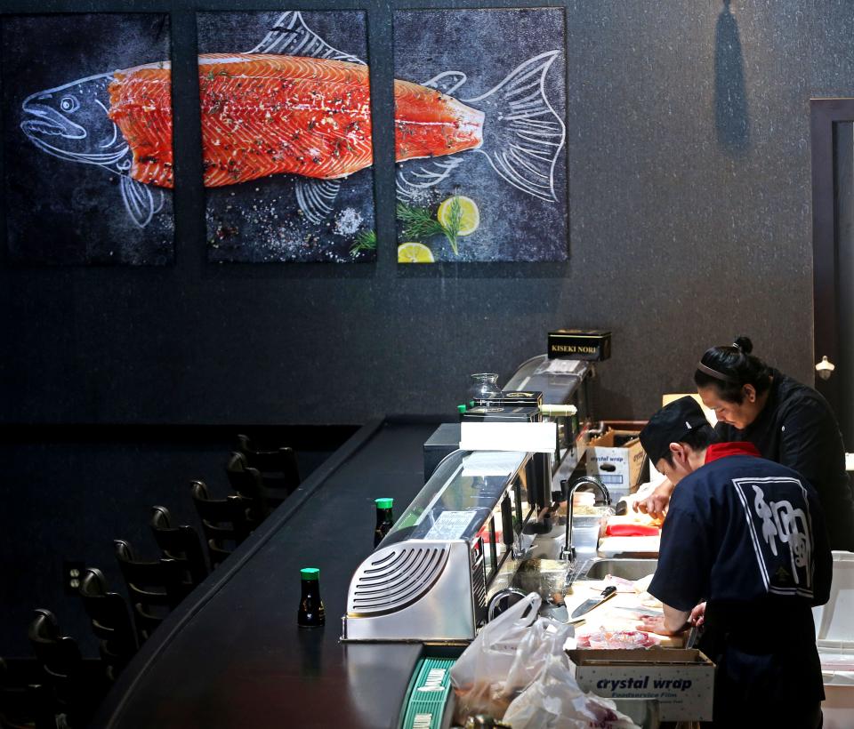 Workers prepare food at the sushi bar at the new Ninja Steakhouse on Feb. 1.