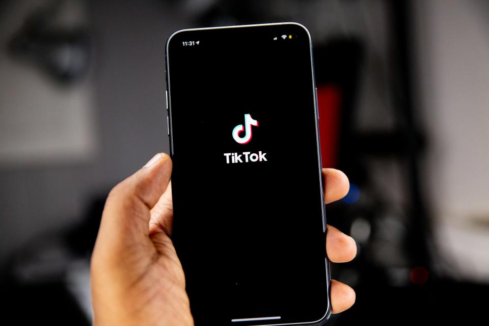 a person holding a phone with TikTok pulled up.