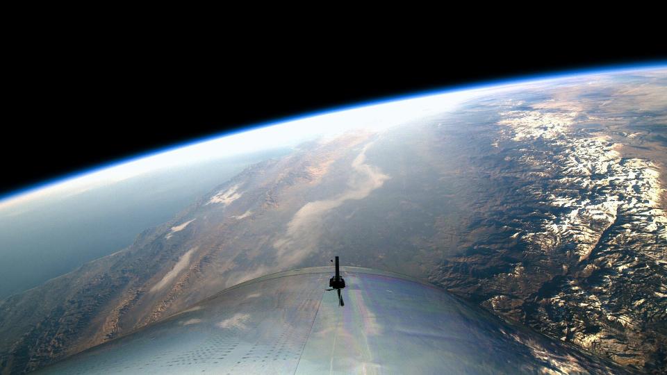 A Virgin Galactic spacecraft above the earth