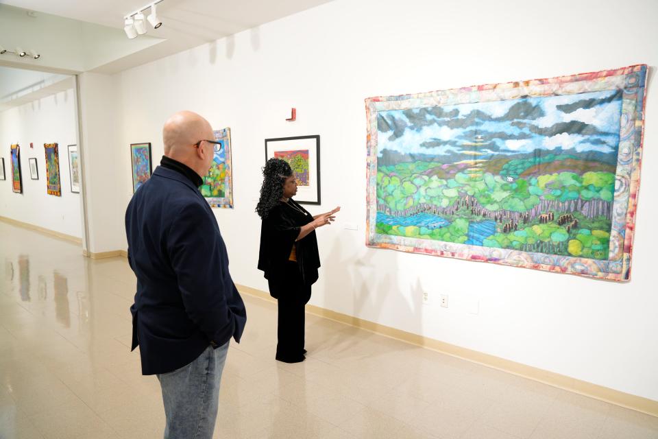 From left, Tim Blunk, director or Gallery Bergen at BCC and Gwenette Reese, a friend of Faith Ringgold, look at Coming to Jones Road #1 at BCC. An exhibit of Faith Ringgold is on display at the Gallery Bergen at Bergen Community College in Paramus, NJ on Thursday Feb. 2, 2023. 