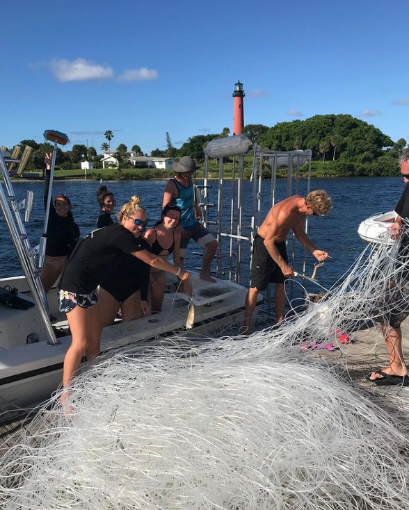 A photo of captain John Moore Jr. and passengers unloading miles of longline onto a dock in Jupiter went viral on Aug. 10, 2020. Prosecutors would use this photo, and others, to prosecute Moore and his crewmate, Tanner Mansell, for theft in federal court.