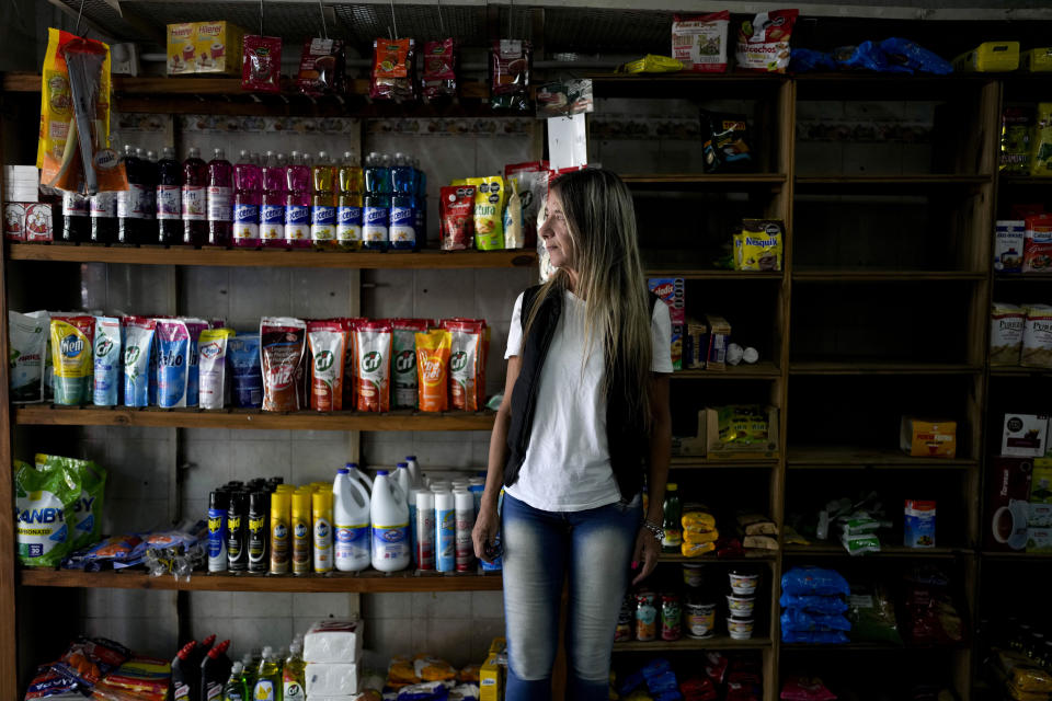 Carla Cavallini poses for a picture inside the grocery store she and her husband opened eight months ago, but that is no longer viable, in Buenos Aires, Argentina, Wednesday, March 6, 2024. Cavallini and her husband are among a large group of Argentines who say their economic situation is worse now than a year ago as a consequence of a series of austerity and deregulation measures ordered by President Javier Milei in his first 100 days in office. (AP Photo/Natacha Pisarenko)