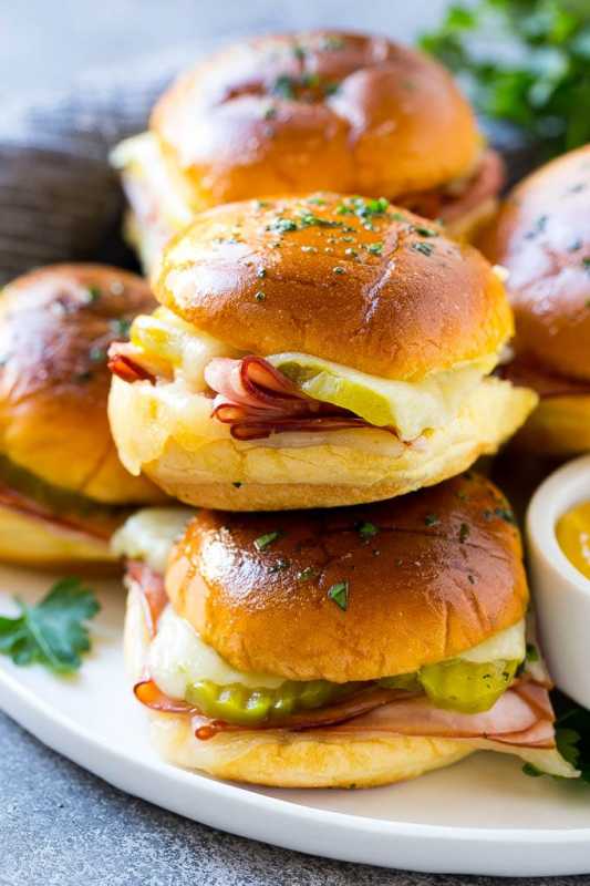 <p>Dinner at the Zoo</p><p>These Cuban sliders are potato buns piled high with meat, cheese and pickles, then brushed with garlic butter and baked to golden brown perfection. The perfect slider sandwich for parties, game day or as an easy dinner option.</p><p><strong>Get the recipe: <a href="https://www.dinneratthezoo.com/cuban-sliders/" rel="nofollow noopener" target="_blank" data-ylk="slk:Sheet Pan Cuban Sliders;elm:context_link;itc:0;sec:content-canvas" class="link ">Sheet Pan Cuban Sliders</a></strong></p><p><strong>Related: <a href="https://parade.com/1235934/parade/best-burger-recipe/" rel="nofollow noopener" target="_blank" data-ylk="slk:The Best Classic Burger Recipe;elm:context_link;itc:0;sec:content-canvas" class="link ">The Best Classic Burger Recipe</a></strong></p>