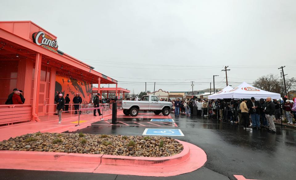 A crowd waits for Raising Cane’s founder Todd Graves and Post Malone to host the grand opening celebration of a Raising Cane’s Restaurant, designed by the singer, in Midvale on Thursday, April 13, 2023. | Kristin Murphy, Deseret News