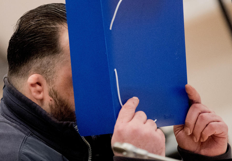 Former nurse Niels Hoegel covers his face as he arrives for the start of his trial in a courtroom in Oldenburg, Germany, October 30, 2018.     Julian Stratenschulte/Pool via REUTERS