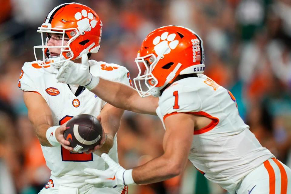 Oct 21, 2023; Miami Gardens, Florida, USA; Clemson Tigers quarterback Cade Klubnik (2) hands the ball off to running back Will Shipley (1) against the Miami Hurricanes during the second quarter at Hard Rock Stadium. Mandatory Credit: Rich Storry-USA TODAY Sports