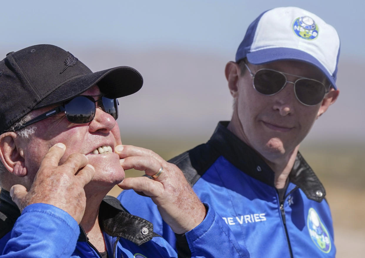 FILE - Glen de Vries, right, takes a look as William Shatner, left, shows what rocket lift off did to his face during a media availability at the spaceport near Van Horn, Texas, Wednesday, Oct. 13, 2021. Glen de Vries, 49, and Thomas P. Fischer, 54, died in crash of a single-engine Cessna 172 that went down Thursday, Nov. 11, in a wooded area of Hampton Township, N.J. (AP Photo/LM Otero, File)