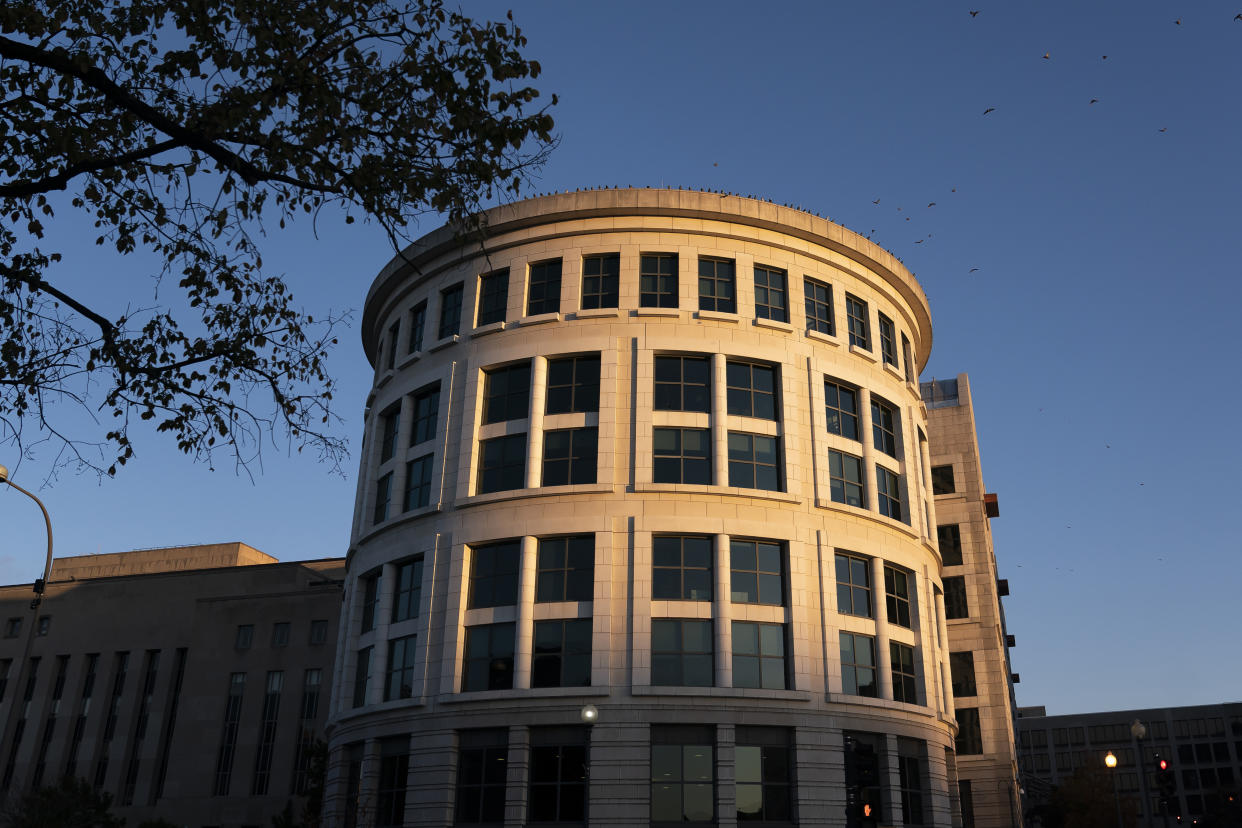 The sun rises on the Federal Courthouse in Washington, ahead of a sentencing hearing for Steve Bannon, longtime ally of former President Donald Trump, convicted of contempt of Congress, on Friday, Oct. 21, 2022. (AP Photo/Nathan Howard)