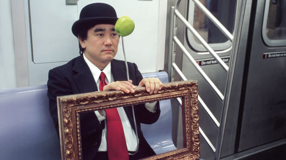 Surrealist René Magritte holds his own self-portrait frame. - Seymour Licht