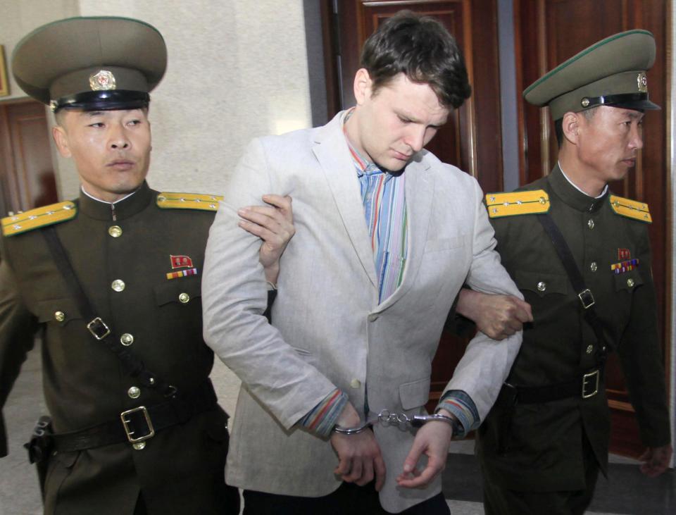 American student Otto Warmbier, center, is escorted at the Supreme Court in Pyongyang, North Korea, Wednesday, March 16, 2016. North Korea's highest court sentenced Warmbier, a 21-year-old University of Virginia undergraduate student, from Wyoming, Ohio, to 15 years in prison with hard labor on Wednesday for subversion. He allegedly attempted to steal a propaganda banner from a restricted area of his hotel at the request of an acquaintance who wanted to hang it in her church.
