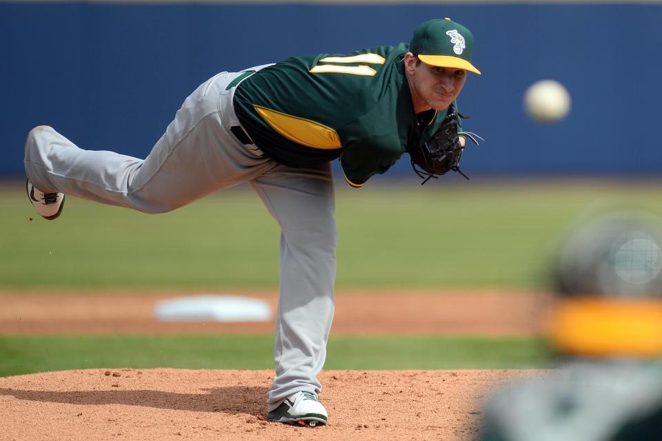 Oakland Athletics starting pitcher Jarrod Parker (11) pitches during the first inning against the Oakland Athletics at Maryvale Baseball Park in Arizona on Mar 5, 2014.