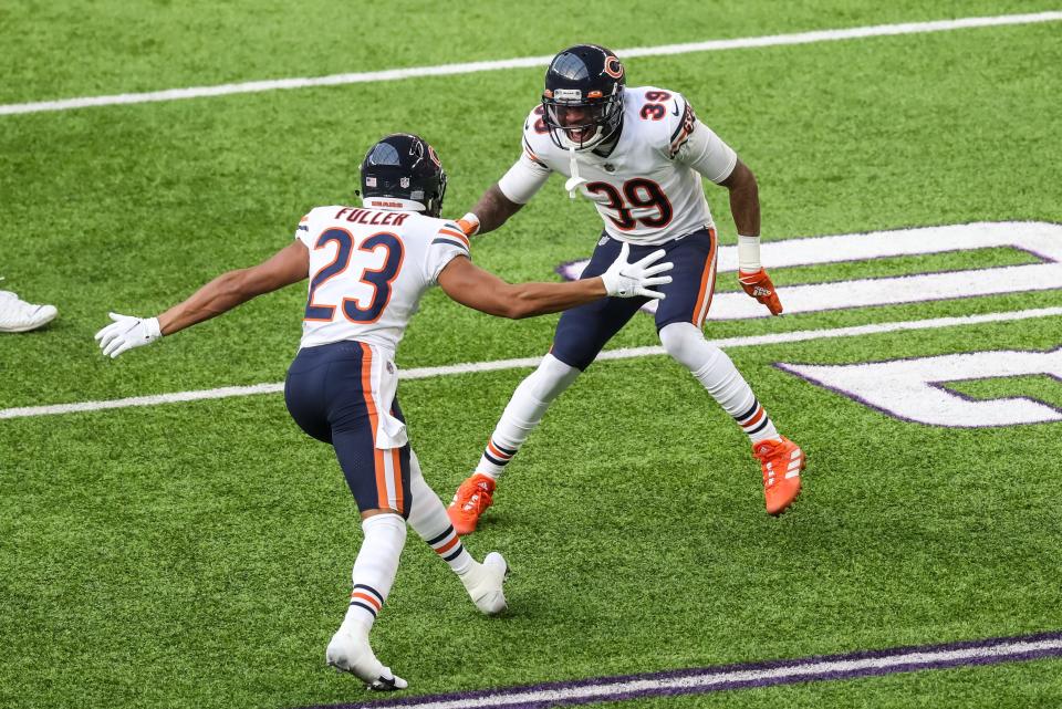 Dec 20, 2020; Minneapolis, Minnesota, USA; Chicago Bears safety Eddie Jackson (39) and cornerback Kyle Fuller (23) celebrate a fourth down stop during the second quarter against the Minnesota Vikings at U.S. Bank Stadium. Mandatory Credit: Brace Hemmelgarn-USA TODAY Sports