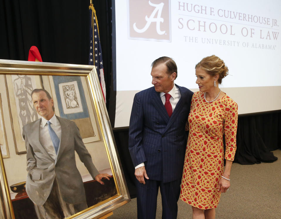 In this Sept. 20, 2018, photo, Hugh F. Culverhouse Jr. and his wife, Eliza, look at a portrait of him that will hang in the University of Alabama law school in Tuscaloosa, Ala. The university appears poised to reject a $26.5 million pledge by Culverhouse, who recently called on students to boycott the university over the state’s new abortion ban. (Gary Cosby Jr./The Tuscaloosa News via AP)